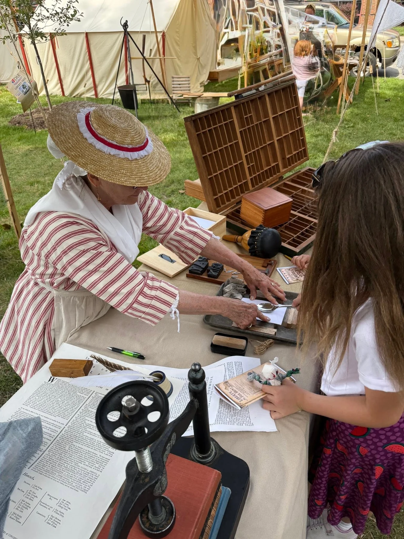 A visitor joins an interpreter for an activity at the fair.